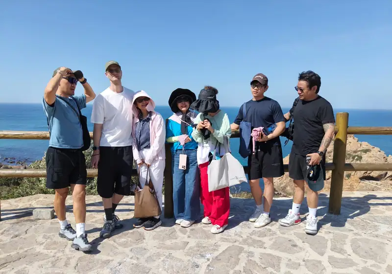 A group of travellers on a private custom day trip at a viewpoint over the Atlantic near Tangier