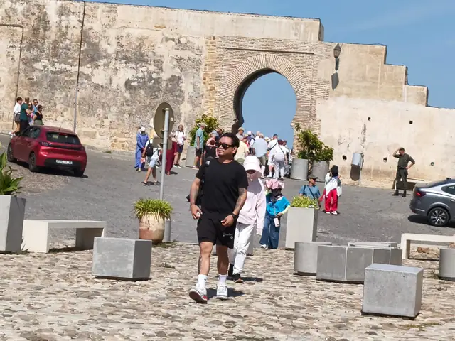 Travellers walking from the Kasbah gate in the old medina of Tangier